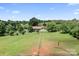 An aerial shot of a home with a sprawling lawn and mature trees in the background at 4026 Biggerstaff Rd, Maiden, NC 28650
