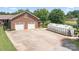 Aerial view of a brick home. A large concrete driveway and greenhouse can be seen on the property at 4026 Biggerstaff Rd, Maiden, NC 28650