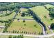 An expansive aerial view showing property lines of a lush, green estate with fields, trees, and buildings at 4026 Biggerstaff Rd, Maiden, NC 28650