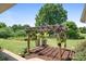 A pergola stands in the yard. The garden is full of colorful blooms and lush greenery at 4026 Biggerstaff Rd, Maiden, NC 28650
