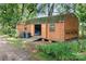 Wooden barn with open doors, surrounded by greenery and potted plants, providing ample storage space at 4026 Biggerstaff Rd, Maiden, NC 28650
