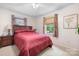Cozy bedroom featuring a comfortable bed and neutral decor, illuminated by natural light at 4026 Biggerstaff Rd, Maiden, NC 28650