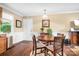 A lovely dining area with round wood table, four chairs, and wood-look floors at 4026 Biggerstaff Rd, Maiden, NC 28650