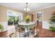 A bright dining area with table and chairs, opening to sunroom, with wood-look floors at 4026 Biggerstaff Rd, Maiden, NC 28650