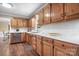An oak-filled kitchen with stainless appliances, white counters and backsplash, and warm wood-look floors at 4026 Biggerstaff Rd, Maiden, NC 28650