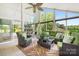 Sun-filled room with soaring ceilings, a ceiling fan, tile floors, comfortable furniture and multiple potted plants at 4026 Biggerstaff Rd, Maiden, NC 28650
