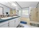 Bright bathroom featuring a double sink vanity, walk-in shower, and soaking tub at 4104 Pebblebrook Sw Cir, Concord, NC 28027