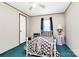 Bedroom with white metal frame bed, colorful bedding and lots of natural light at 4104 Pebblebrook Sw Cir, Concord, NC 28027