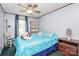 Comfortable bedroom featuring a ceiling fan, a bedside table and a cozy stuffed animal at 4104 Pebblebrook Sw Cir, Concord, NC 28027