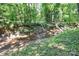 Picturesque creek winding through a serene wooded landscape, offering a tranquil natural escape at 4104 Pebblebrook Sw Cir, Concord, NC 28027