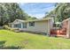 A quaint home featuring a small outdoor deck, complemented by lush greenery and an expansive, well-kept lawn area at 4104 Pebblebrook Sw Cir, Concord, NC 28027
