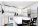 Bright kitchen featuring white cabinets, marble countertops, stainless steel appliances, and an island with bar seating at 4104 Pebblebrook Sw Cir, Concord, NC 28027