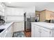 Modern kitchen featuring white cabinetry, marble countertops, and a stainless steel refrigerator, offering ample storage at 4104 Pebblebrook Sw Cir, Concord, NC 28027
