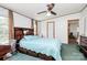 Charming main bedroom with a ceiling fan, blue bedspread, and ensuite bathroom at 4104 Pebblebrook Sw Cir, Concord, NC 28027