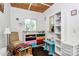 Bright spare room with wood ceiling, colorful cabinets, and a cozy chair at 4104 Pebblebrook Sw Cir, Concord, NC 28027
