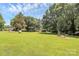 Lush lawn with mature trees offers a serene and inviting outdoor space at 4104 Pebblebrook Sw Cir, Concord, NC 28027