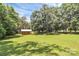 Spacious lawn featuring mature trees and a quaint shed, offering an idyllic outdoor setting at 4104 Pebblebrook Sw Cir, Concord, NC 28027