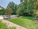 Secluded backyard with manicured lawn, beautiful landscaping, and fenced perimeter at 4300 Cameron Oaks Dr, Charlotte, NC 28211