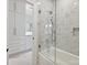 Elegant bathroom featuring marble tile, glass shower door, and custom white cabinets at 4300 Cameron Oaks Dr, Charlotte, NC 28211