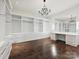 Large walk-in closet with custom built-ins, drawers, and a vanity area at 4300 Cameron Oaks Dr, Charlotte, NC 28211