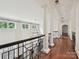 Elegant hallway with hardwood floors, classic columns, and decorative chandelier at 4300 Cameron Oaks Dr, Charlotte, NC 28211
