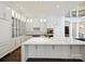 Bright kitchen with white cabinets, a large island, and stainless steel appliances at 4300 Cameron Oaks Dr, Charlotte, NC 28211