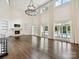 Bright and airy living room with a fireplace, built-in shelves, hardwood flooring, and access to a pool at 4300 Cameron Oaks Dr, Charlotte, NC 28211