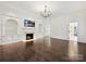 Cozy living room with a fireplace, built-in shelves, hardwood floors and a TV at 4300 Cameron Oaks Dr, Charlotte, NC 28211