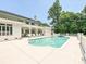 A luxurious backyard features a sparkling pool, a hot tub, and ample seating for entertaining at 4300 Cameron Oaks Dr, Charlotte, NC 28211