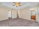 Bright bedroom with carpet and neutral walls with multiple doorways, including one to the bathroom at 5322 Jocelyn Ln, Charlotte, NC 28269