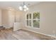 Bright dining area with natural light from large windows, featuring hardwood floors and neutral wall color at 5322 Jocelyn Ln, Charlotte, NC 28269
