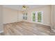 Spacious living space with hardwood floors, fan, and a glass doors that provide natural light and outdoor access at 5322 Jocelyn Ln, Charlotte, NC 28269