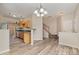 Open-concept living space showcasing hardwood floors, neutral paint and a staircase leading to the upper level at 5322 Jocelyn Ln, Charlotte, NC 28269