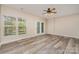 Bright living area with natural light from large windows and glass doors, hardwood floors and neutral colored walls at 5322 Jocelyn Ln, Charlotte, NC 28269
