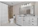 This bathroom offers an updated vanity, marble countertop, and a shower with stylish tile and fixtures at 5916 Cashion Rd, Huntersville, NC 28078