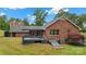 Expansive backyard with a brick home that features an outdoor deck and convenient basement access at 5916 Cashion Rd, Huntersville, NC 28078