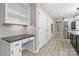 Hallway with a built-in desk and cabinets, leading to the kitchen with stainless steel appliances at 5916 Cashion Rd, Huntersville, NC 28078