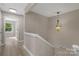 Upstairs hallway featuring modern colors, leading to bedrooms with natural light at 5916 Cashion Rd, Huntersville, NC 28078