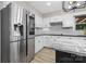 Updated kitchen with stainless steel refrigerator, white cabinets, granite countertops, and new appliances at 5916 Cashion Rd, Huntersville, NC 28078