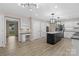 Spacious kitchen featuring new floors, stainless appliances, a large island, and an adjacent desk area at 5916 Cashion Rd, Huntersville, NC 28078