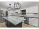 Modern kitchen with white cabinets, stainless steel appliances, and marble countertops at 5916 Cashion Rd, Huntersville, NC 28078