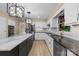 Bright kitchen with white cabinetry, stainless appliances, an island with granite counters, and stylish lighting at 5916 Cashion Rd, Huntersville, NC 28078