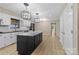 Open kitchen with an island, stainless appliances, and new floors, offering a modern and inviting space at 5916 Cashion Rd, Huntersville, NC 28078