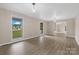 Wide angle view of a neutral living room with wood-look floors and large windows at 5916 Cashion Rd, Huntersville, NC 28078