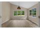 Corner view of the room showcasing a window, neutral paint, and wood-look flooring at 5916 Cashion Rd, Huntersville, NC 28078