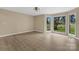 Spacious living room offers great natural light with large windows showcasing the neighborhood and gleaming hardwood floors at 5916 Cashion Rd, Huntersville, NC 28078