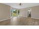 Bright, sunny living room features large windows overlooking the front yard and entryway to full bathroom at 5916 Cashion Rd, Huntersville, NC 28078
