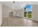 Open-concept living room boasts wood-look floors, natural light, and a view to the outdoors at 5916 Cashion Rd, Huntersville, NC 28078