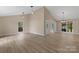 Bright and airy living room with wood-look floors and plenty of natural light at 5916 Cashion Rd, Huntersville, NC 28078