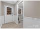 Mud room with white door and trim, featuring beadboard and an adjacent laundry area at 5916 Cashion Rd, Huntersville, NC 28078